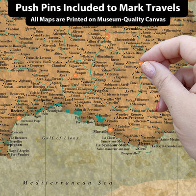 The image is a close-up of a map of Europe, with a hand pointing to a specific location on the map.