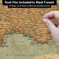 The image is a close-up of a map of Europe, with a hand pointing to a specific location on the map.