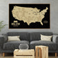 a large framed map of the United States with football players depicted on it, hanging on a wall above a gray couch and a coffee table in a living room setting.
