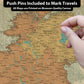 a person pointing to a map with pins on it