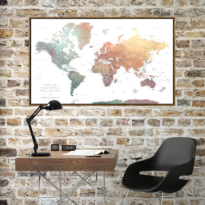 a large world map hanging on a brick wall above a wooden desk with a black desk lamp and a black chair.