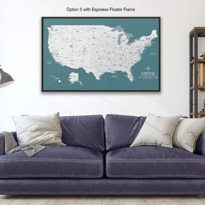 a large framed map of the United States with a dark blue couch and pillows in the foreground.