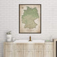 a bathroom setting with a large map of Germany hanging on the wall above a wooden cabinet with a sink.