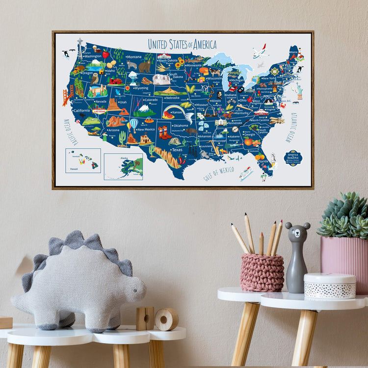 a large, colorful map of the United States, with various landmarks and locations marked across the country. The map is displayed on a wall, and there are some small decorative items, such as a stuffed animal and a small figurine, placed on a table below the map.