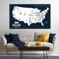 a large map of the United States with various locations marked, and a cozy living room setting with a couch, coffee table, and decorative items.