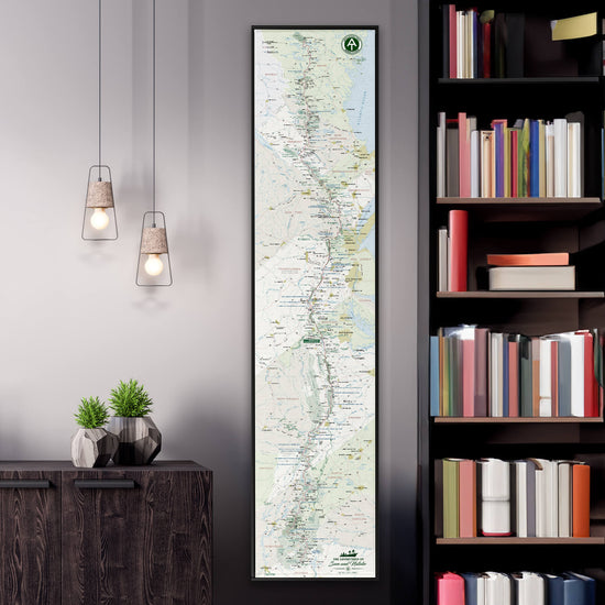 a large vertical map of South America hanging on a wall, with a bookshelf filled with books to the right side.