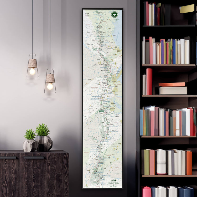a large vertical map of South America hanging on a wall, with a bookshelf filled with books to the right side.