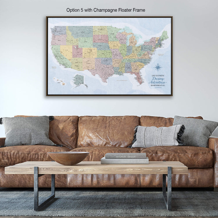 a large framed map of the United States hanging on a wall above a brown leather couch in a living room setting.
