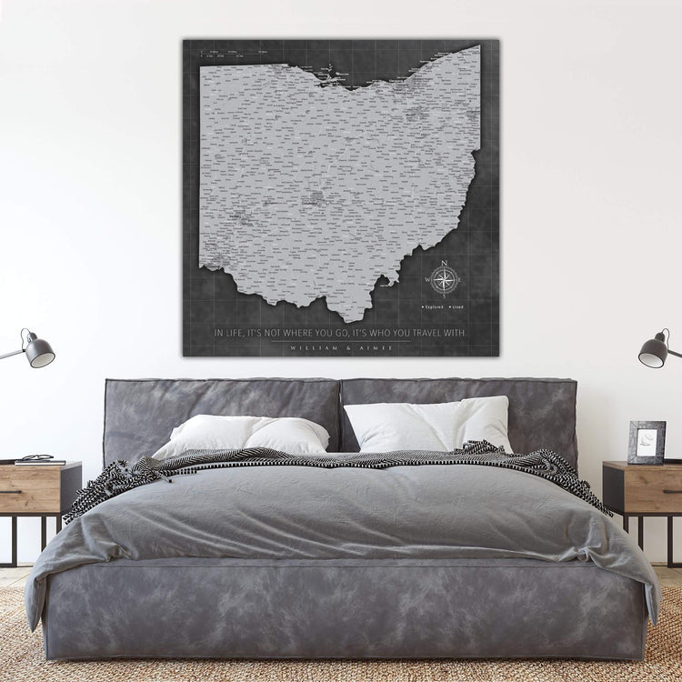 a bedroom with a bed and a large poster on the wall